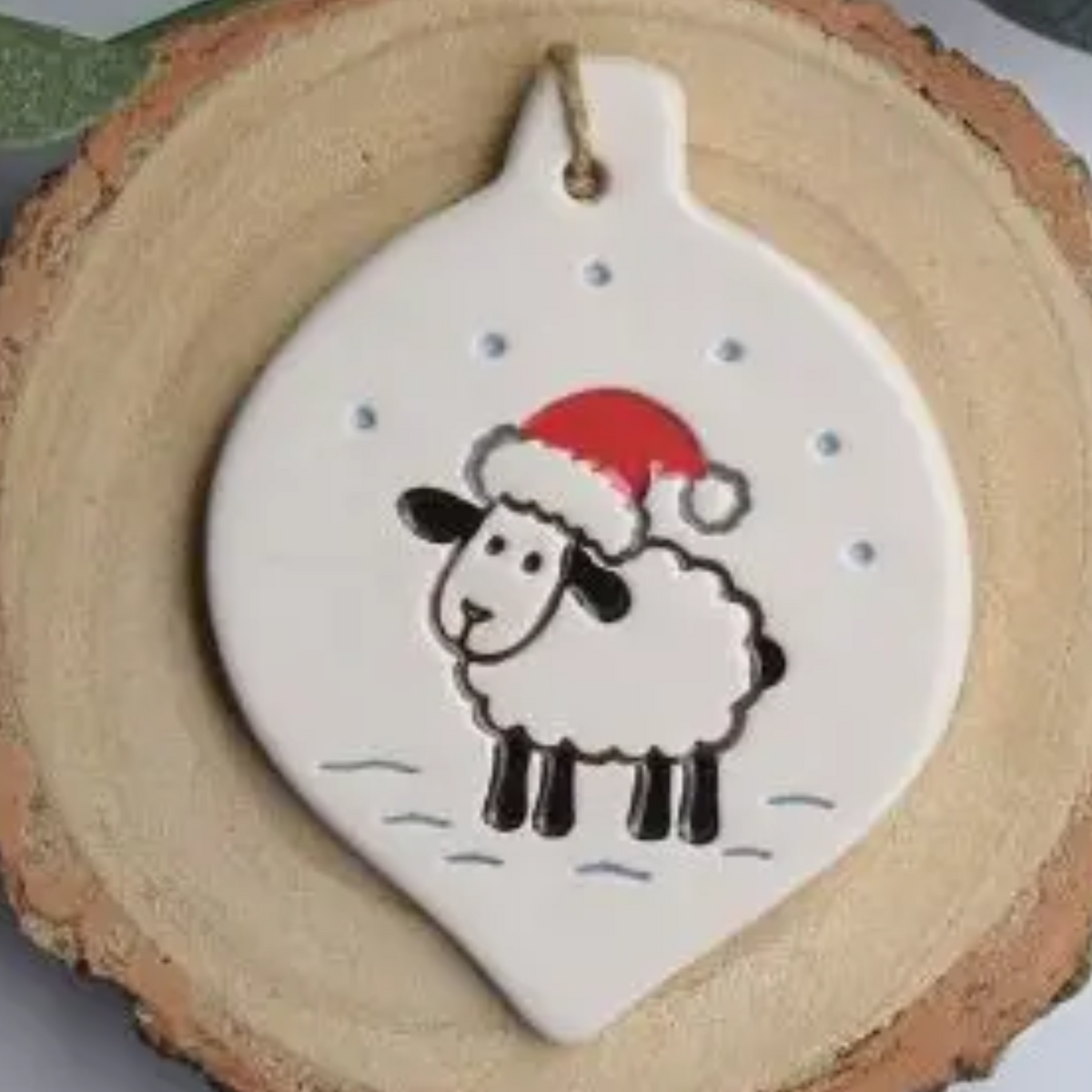 Ceramic bauble shaped Christmas decoration of sheep