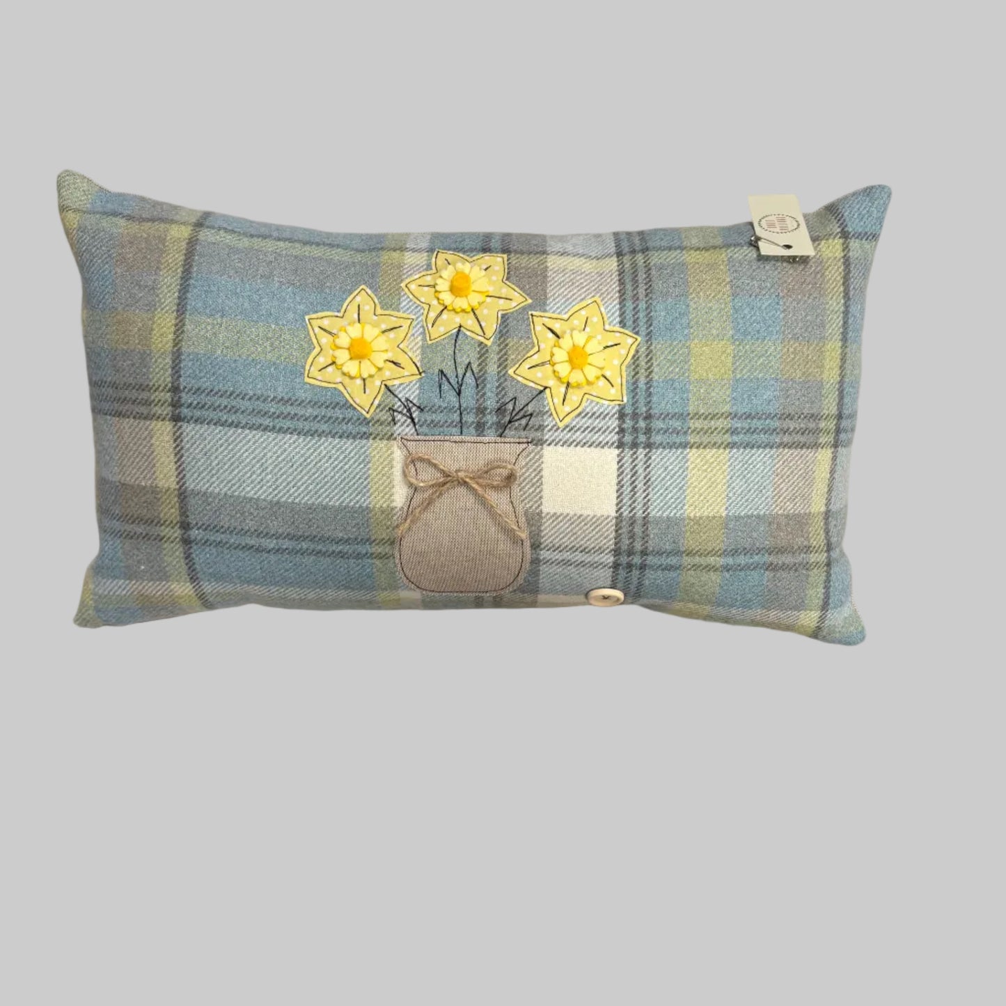 Oblong daffodil vase cushion.