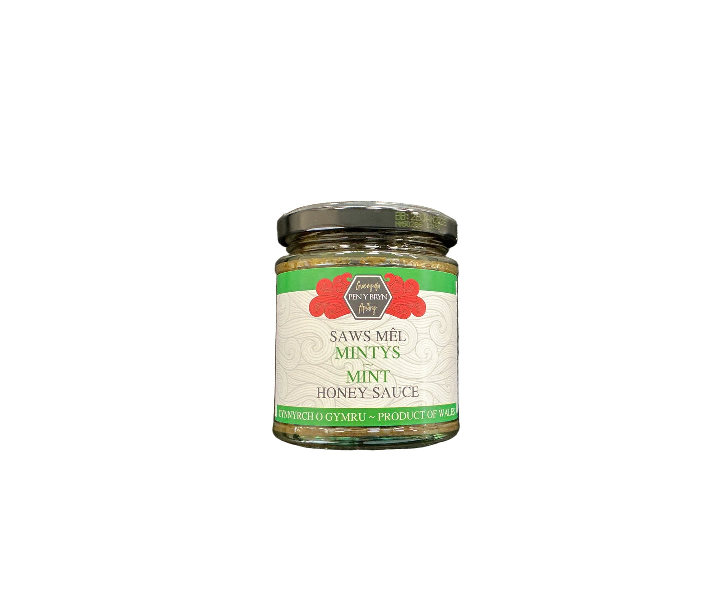 A glass jar of Saws-Mêl Mintys Mint Honey Sauce with a black lid and white label, placed on a dark textured surface.