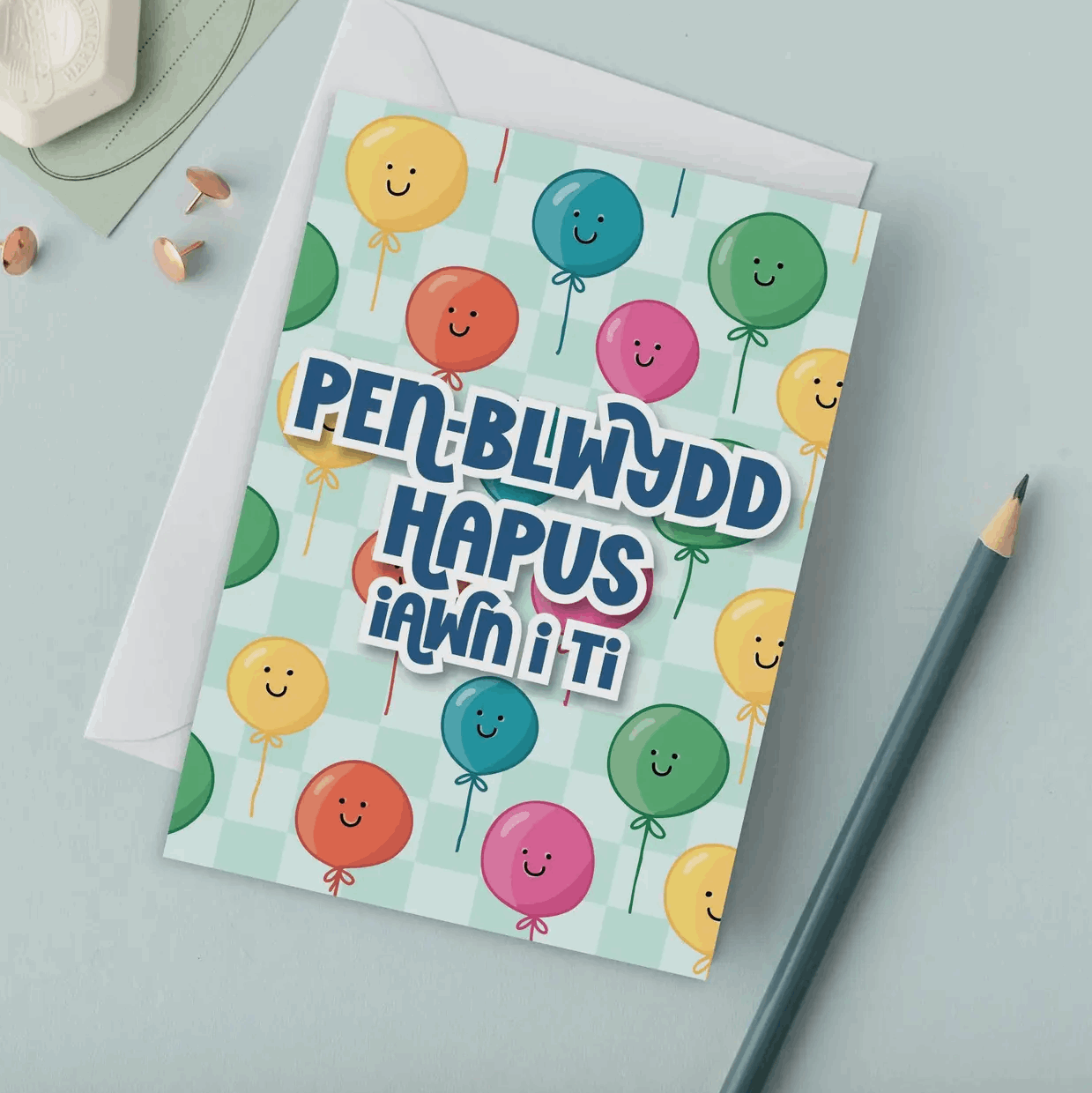 Welsh birthday Greeting card with colourful balloons and text on a light green background