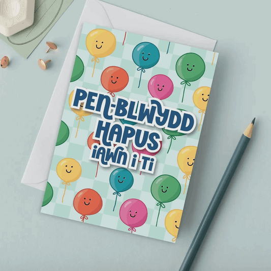 Welsh birthday Greeting card with colourful balloons and text on a light green background