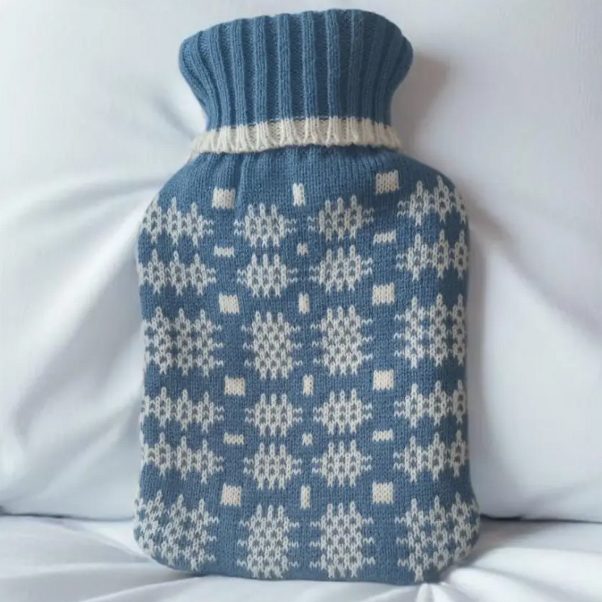 Blue hot water bottle cover in Welsh tapestry design 