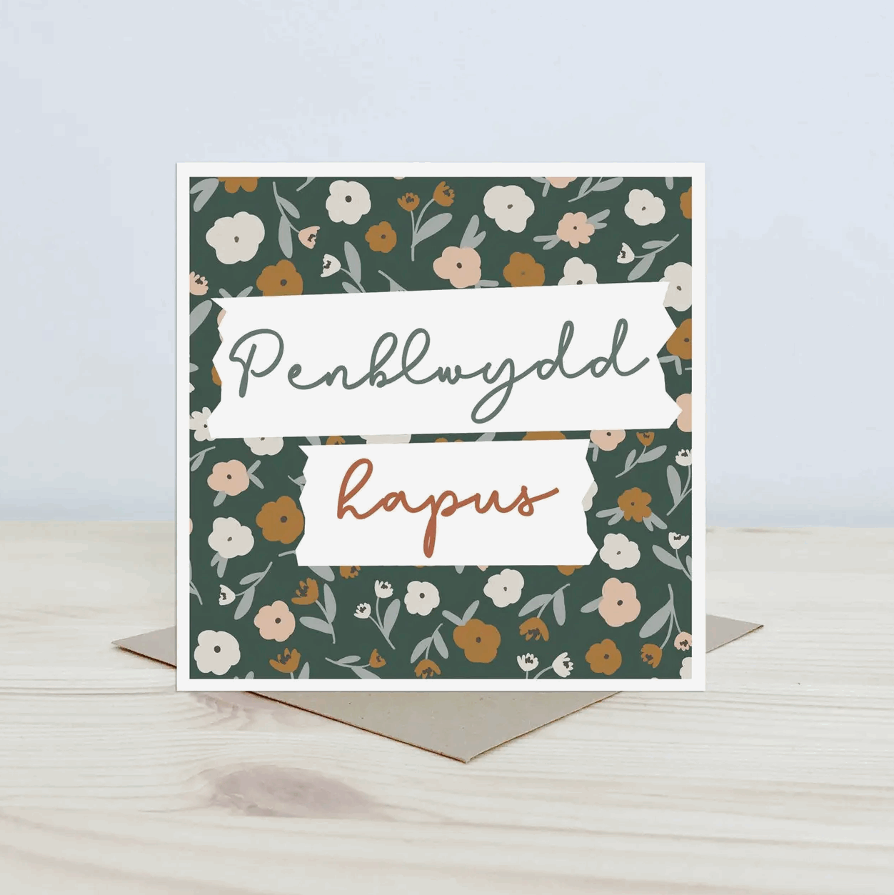 Penblwydd hapus Greeting card with floral pattern and text on a light surface