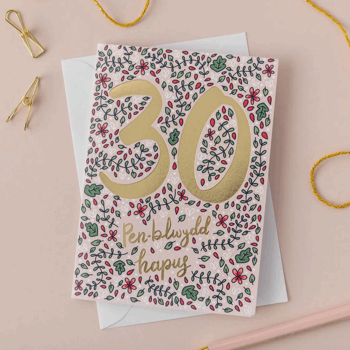 Greeting card with floral design and number 30 on a pink background