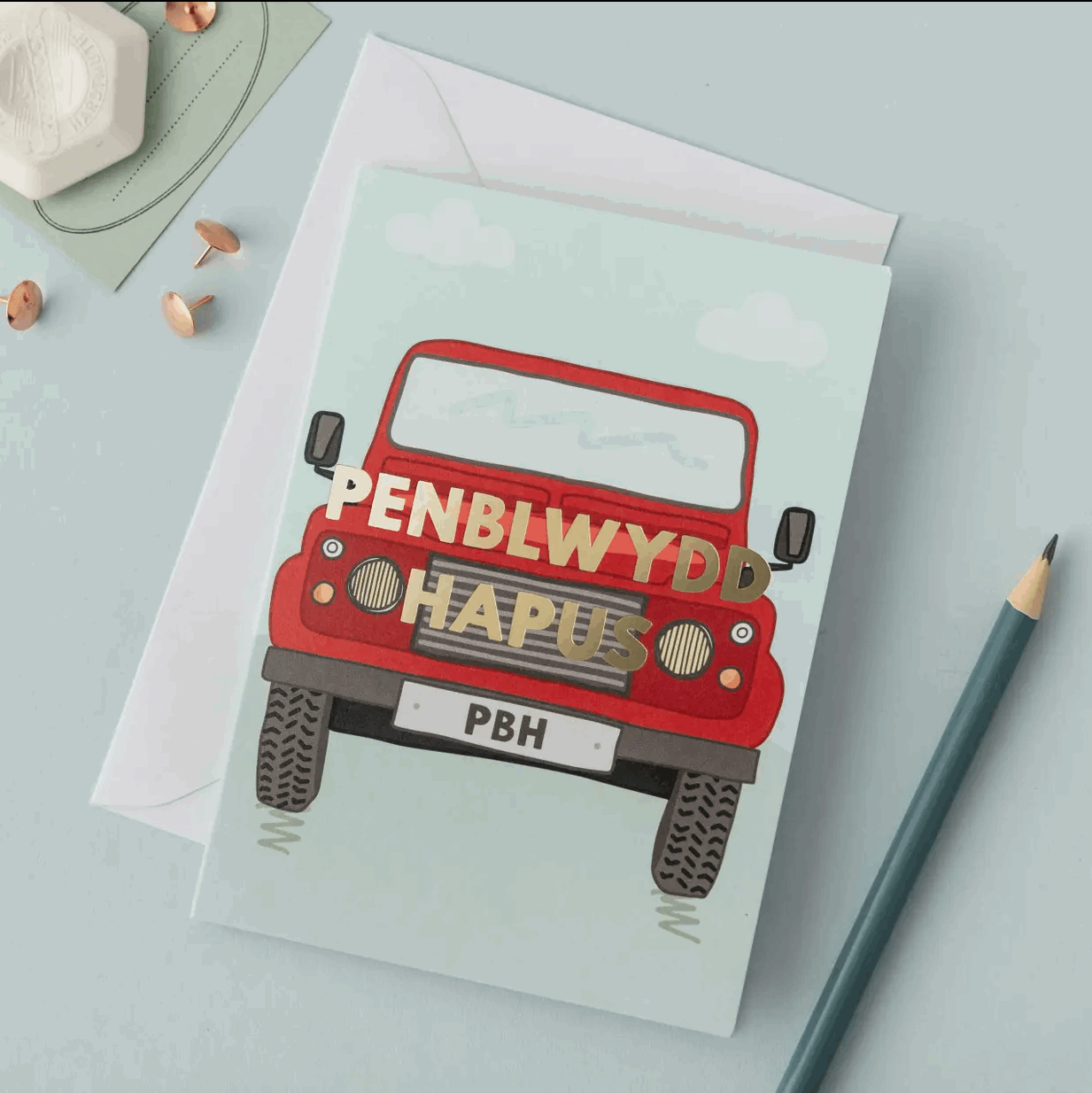 Card with red vehicle illustration and 'Penblwydd Hapus' text on a light blue background
