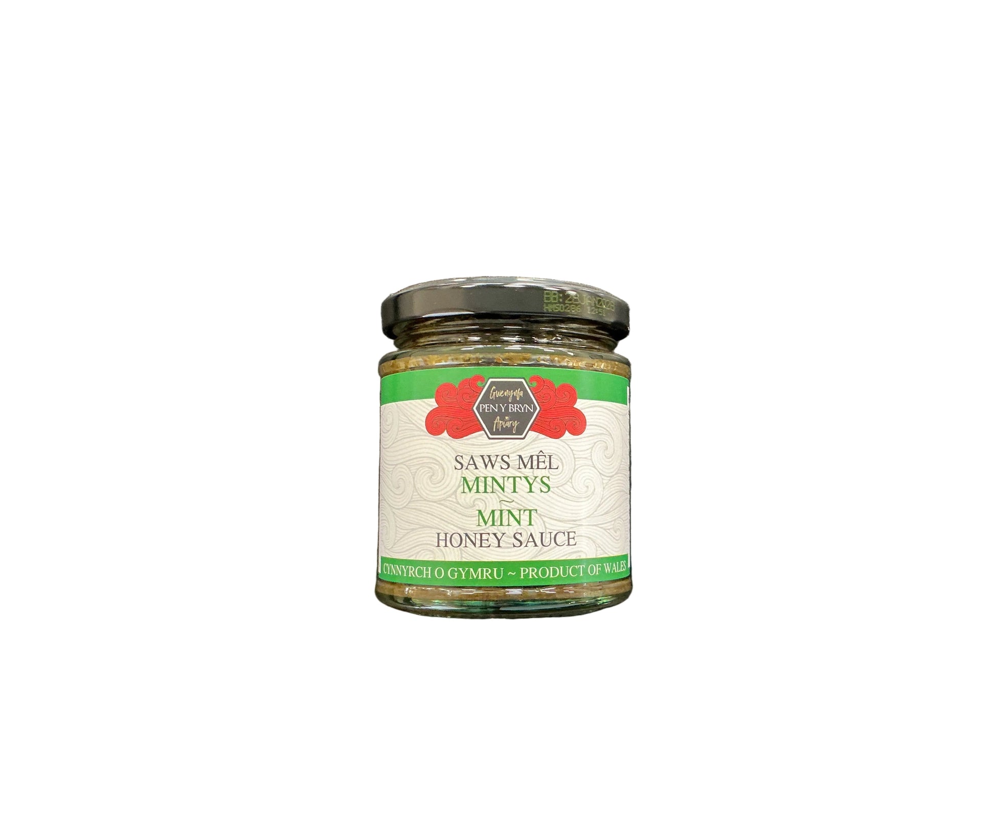 A glass jar of Saws-Mêl Mintys Mint Honey Sauce with a black lid and white label, placed on a dark textured surface.