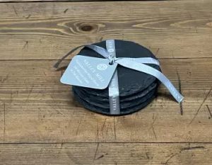Four round Welsh slate coasters
